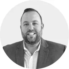 Black and white headshot of Ryan Kuhlman
