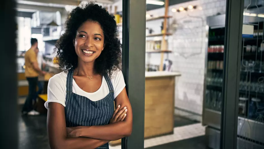 Woman thinking about why she needs insurance coverage for her small business.