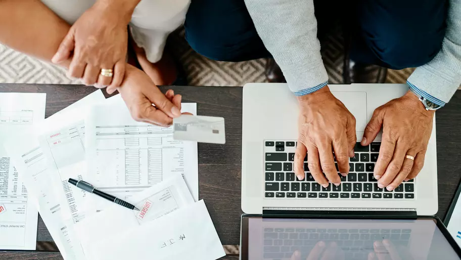 man and woman conducting business on a laptop