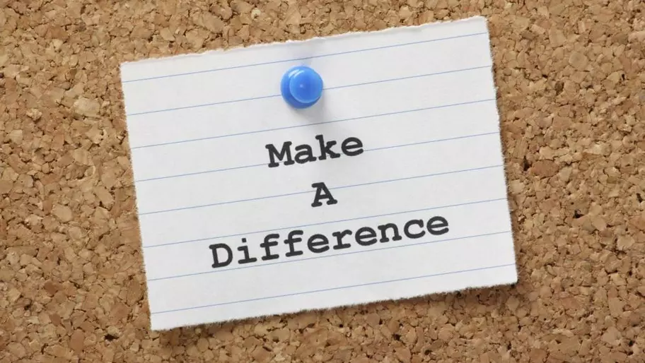 Paper tacked to corkboard that reads Make a Difference