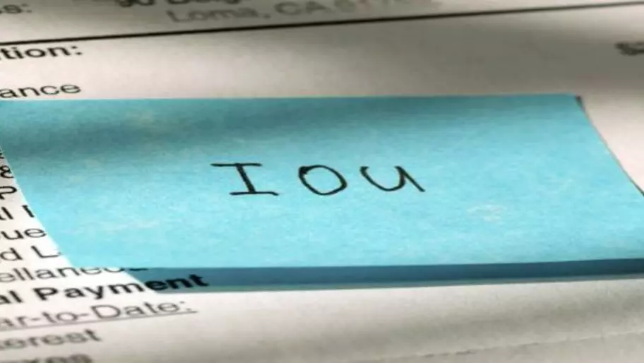 Blue notecard with IOU written in Sharpie
