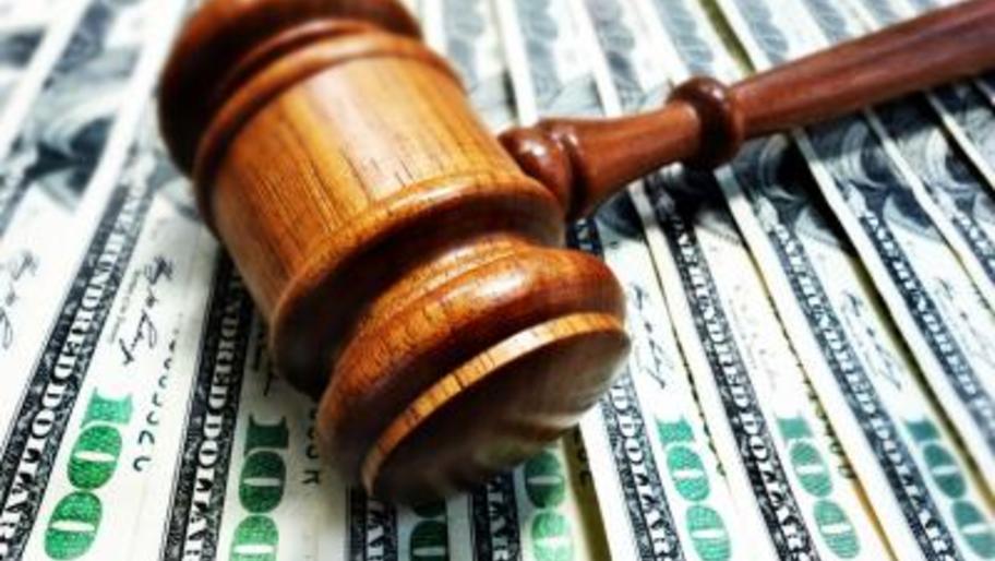 gavel on money signifyiing a lawsuit 
