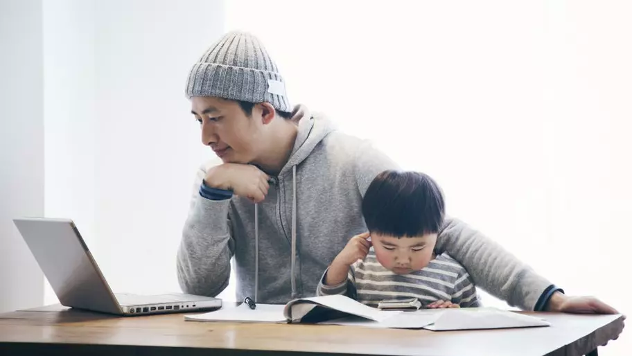Man working from home with his son.