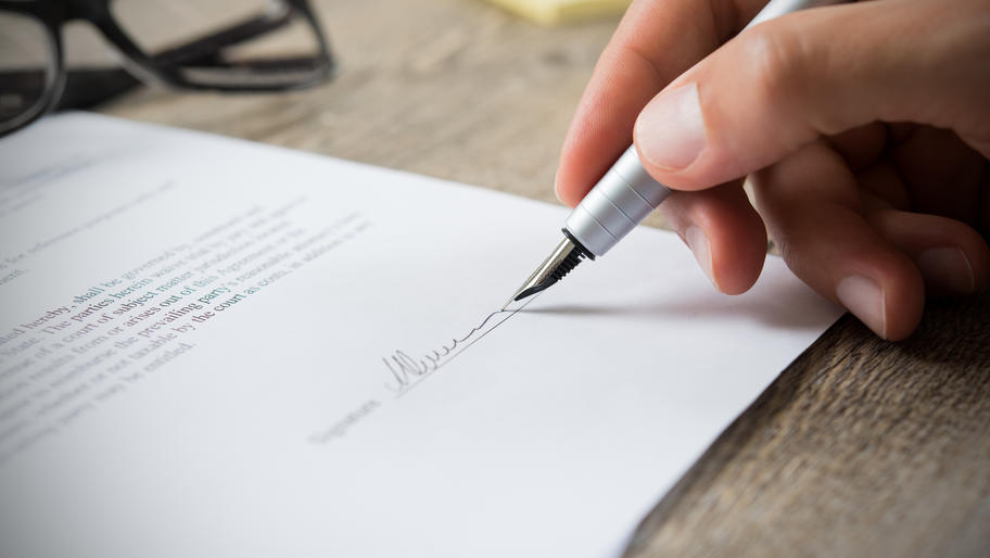 A fountain pen signing a contract