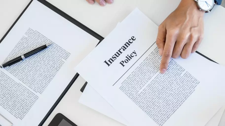 Hand pointed to Insurance policy