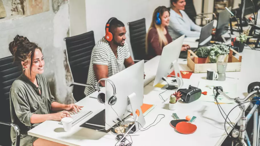 Millennials at the office with laptops