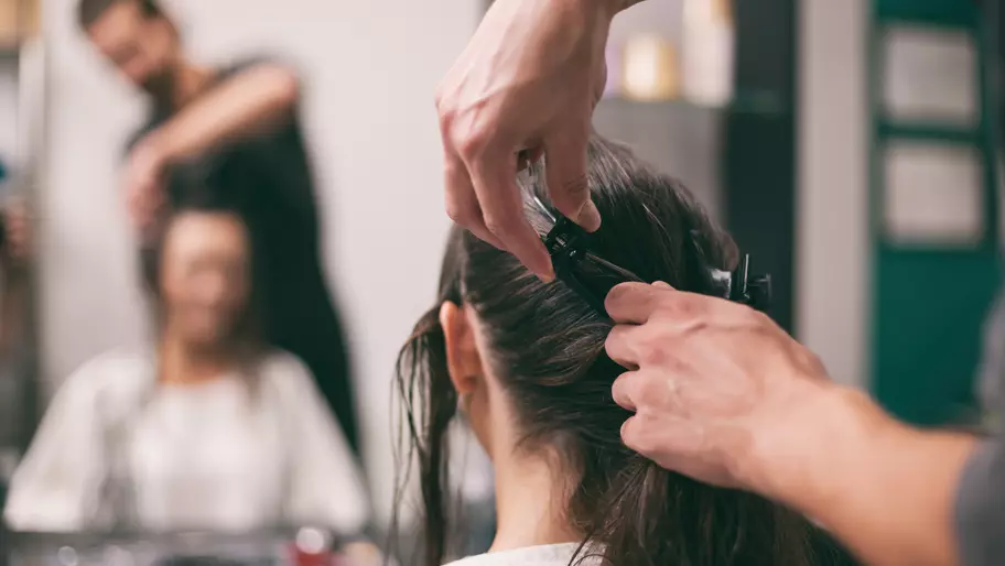 male hairdresser and female client in salon