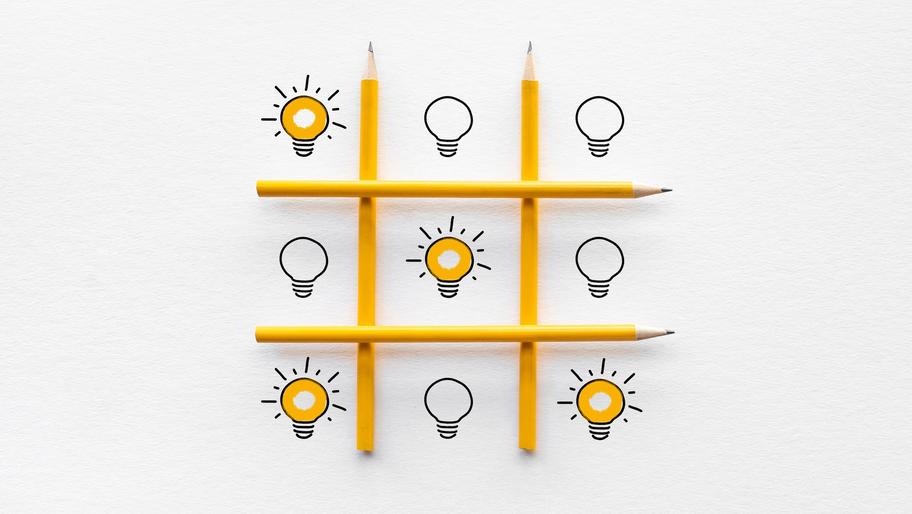 Pencils in Tic-tac-toe formation. Light bulb. idea. Small business contingency planning
