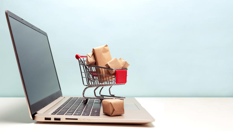 laptop with red shopping cart. How to start an online business.