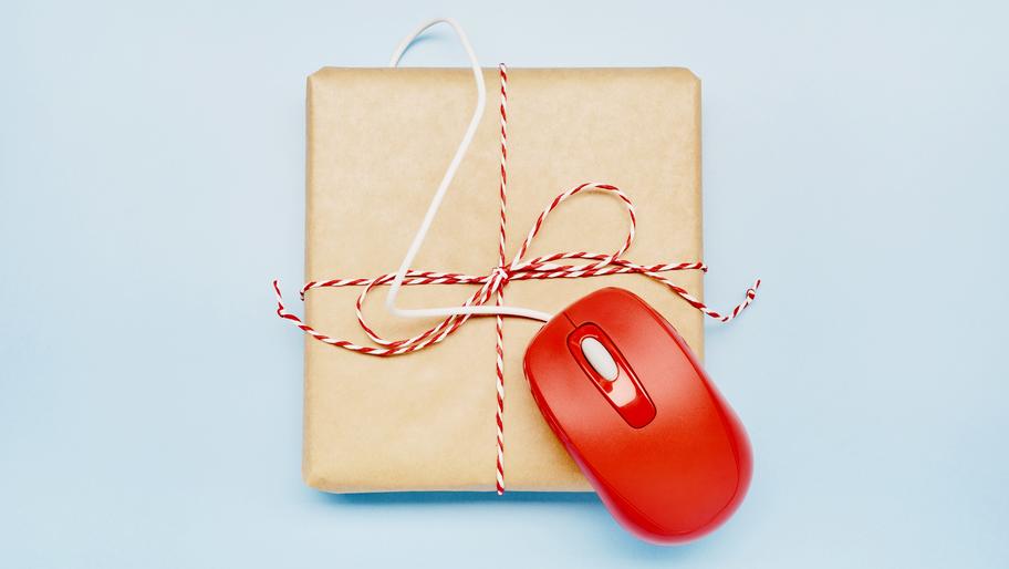 Brown package with strong. Red mouse on top of it. Last-minute holiday sales for small businesses.