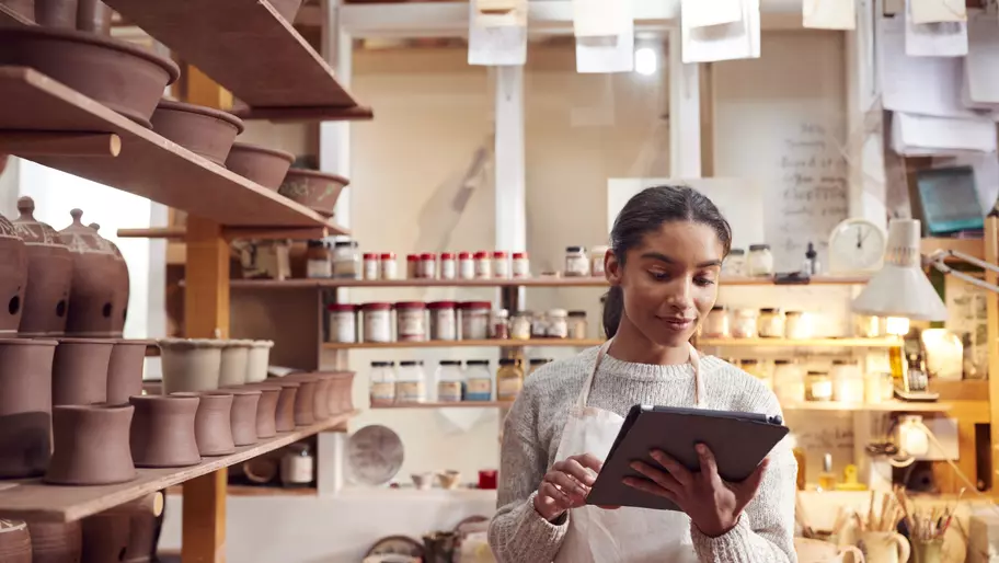 A small business owner uses a tablet at work