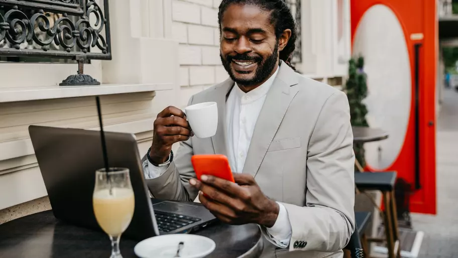 Black small business owner sits at table working without stress