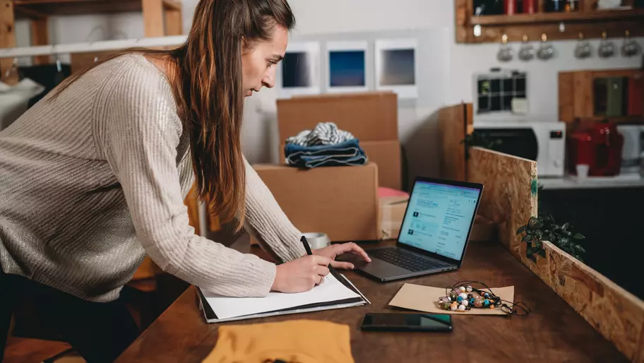 small business owner looking at computer screen with business profile