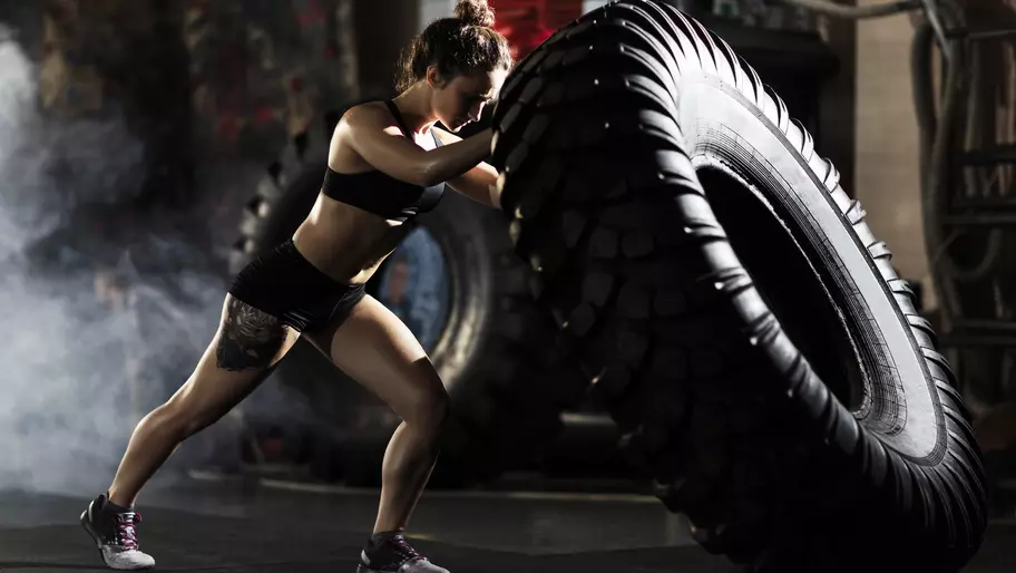 Female with gym tire during CrossFit training