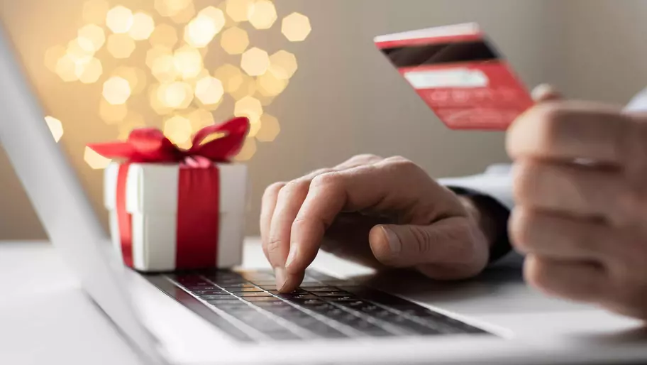 person sitting at computer supporting small business during the holiday shopping season.