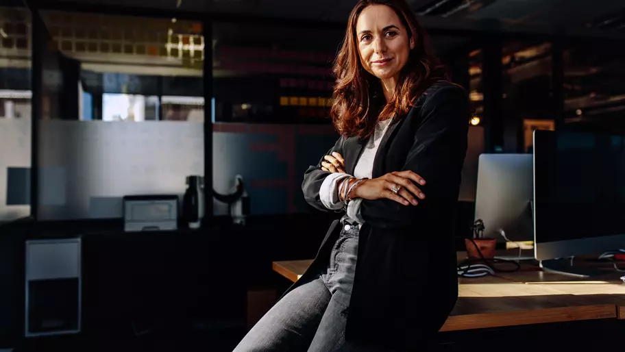 Female entrepreneur in office proud to be her own boss