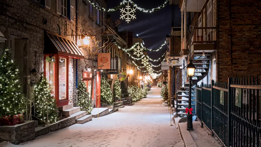 Quaint small town main street with businesses decorated for winter holidays