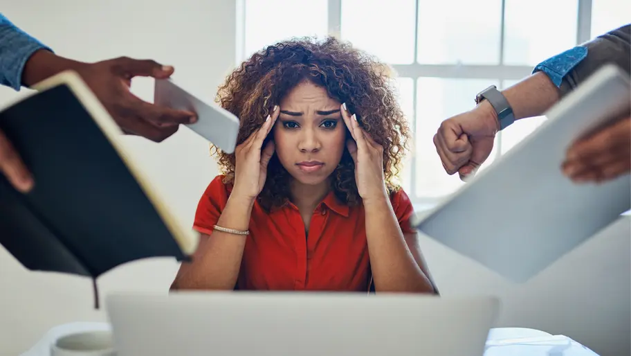 Female consultant stressing, trying not to make a mistake with tasks looming over her.