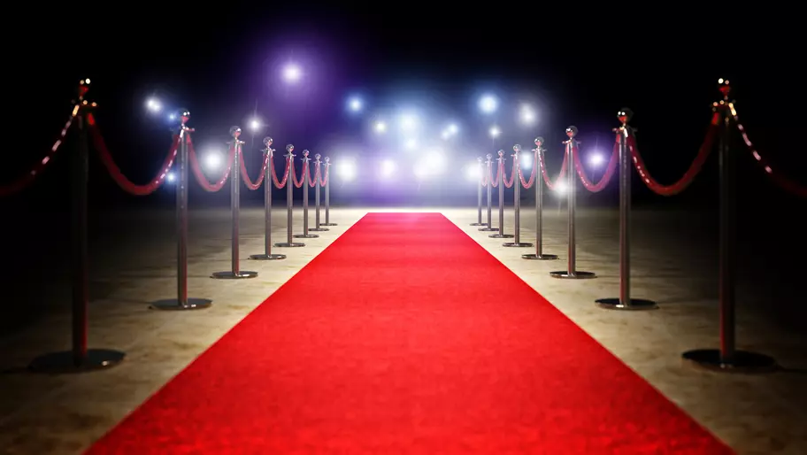 Red carpet set on black backgound with cameras ready to capture small business big moments