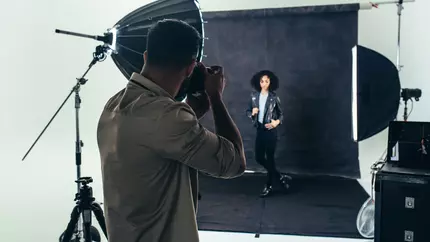 Photographer taking a shot wondering if they need business insurance.