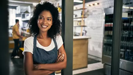 Woman thinking about why she needs insurance coverage for her small business.