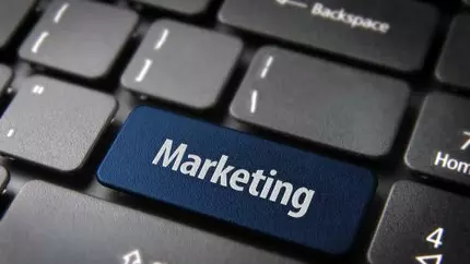 a computer keyboard with the word marketing replacing the enter button