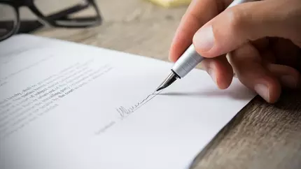 A fountain pen signing a contract