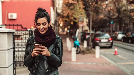Woman on street looking at smart phone