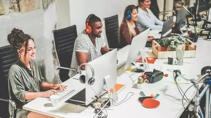 Millennials at the office with laptops
