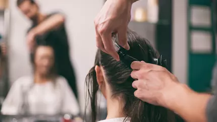 male hairdresser and female client in salon