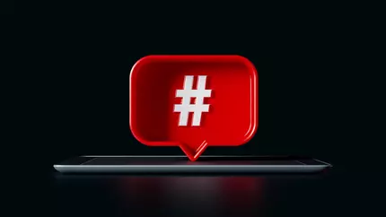 Smart phone with hashtag in a comment coming off of it. Twitter hack. Twitter breach.