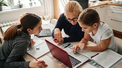 Mother helping homeschool her kids. Laptop notebook. Small business owner.