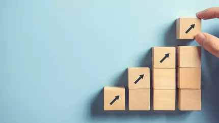 Wood blocks with arrows on them arranged in stairs formation. Strategic planning for business.