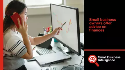 small business owner sitting at desk reviewing her business finances on screen.