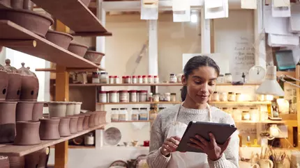 A small business owner uses a tablet at work