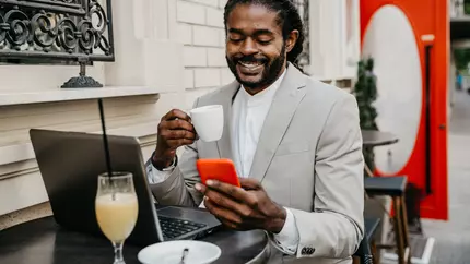 Black small business owner sits at table working without stress