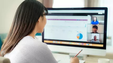 virtual worker at computer on a call with colleagues
