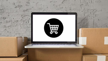 Laptop with shopping cart icon displayed on screen. Image to support dropshipping business