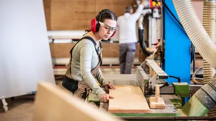 female and and male carpenters working to finish up a job
