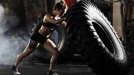 Female with gym tire during CrossFit training