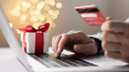 person sitting at computer supporting small business during the holiday shopping season.