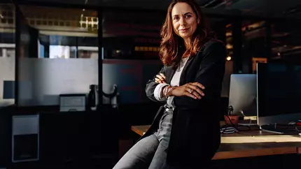 Female entrepreneur in office proud to be her own boss