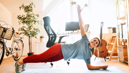 Female small business owner doing yoga, and engaging in other self-care activities to aid in mental well-being