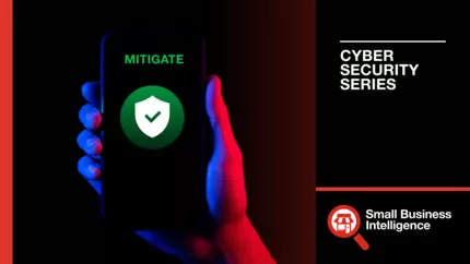 Business owner's hand holding mobile device displaying 'mitigate' on screen for guide on mitigating damage of cyber attack