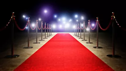Red carpet set on black backgound with cameras ready to capture small business big moments
