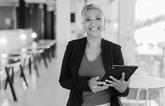 Consultant smiling at camera and holding a tablet