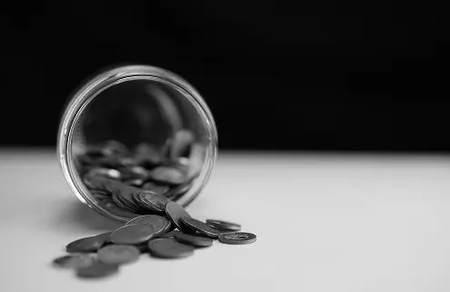 Photograph of a jar of change on its side
