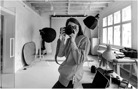 Head on view of a female photographer taking a picture