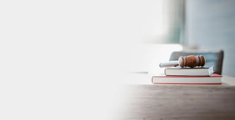 Background image, books on a desk with a gavel on top
