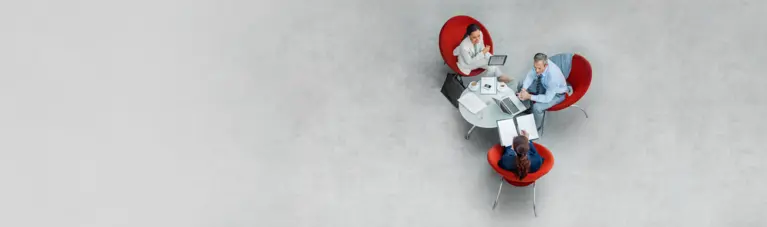 Agents sitting around table in a meeting
